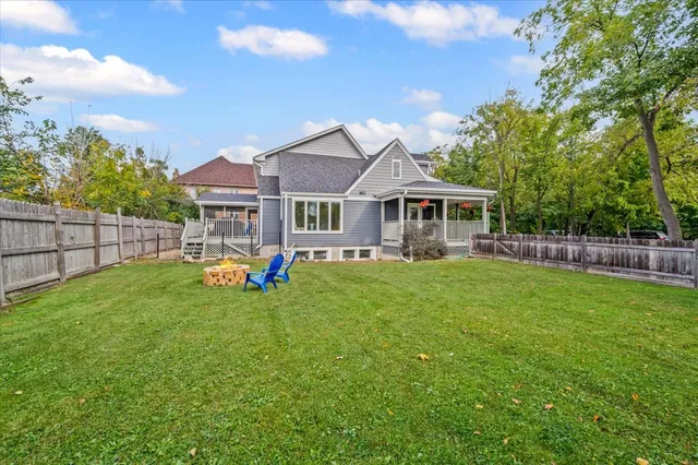 a view of a house with a yard table and chairs