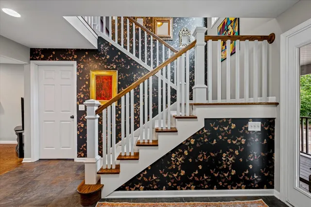 a view of entryway with wooden floor and stairs