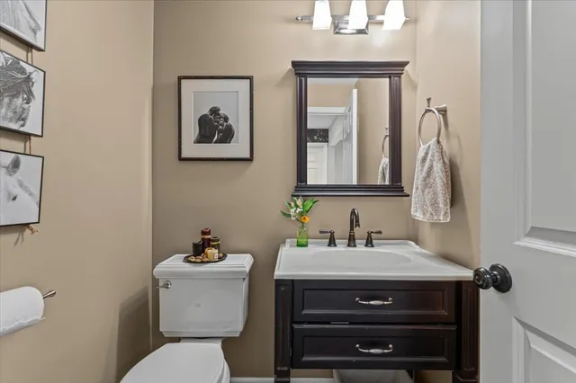 a bathroom with a toilet a sink and mirror