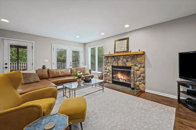 a living room with furniture a window and a fireplace