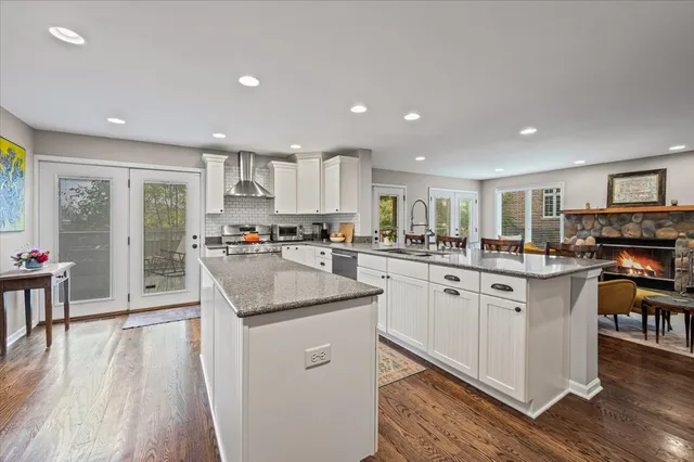 a kitchen with white cabinets and sink