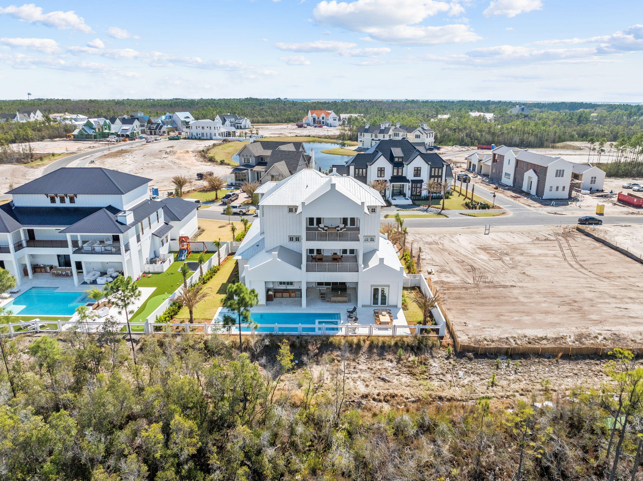 450 Windsong Dr Inlet Beach Inlet Beach, FL 32461 - Photo 2 of 90 an aerial view of a house with a garden and lake view