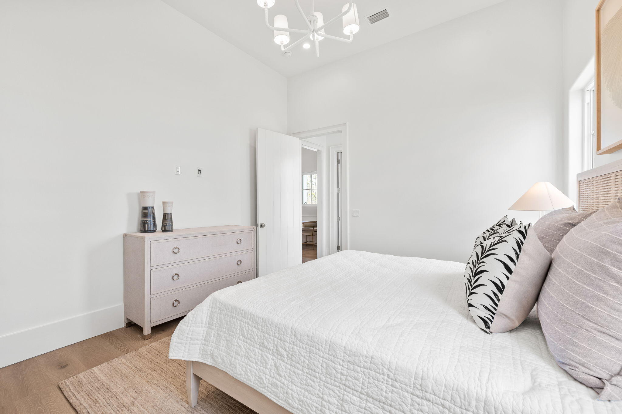 450 Windsong Dr Inlet Beach Inlet Beach, FL 32461 - Photo 36 of 90 a bedroom with a large bed and a chandelier