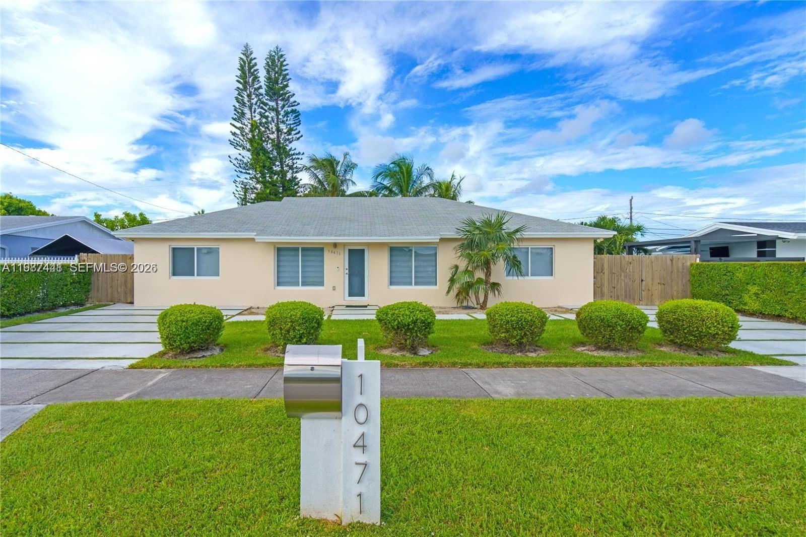 10471 Southwest 164th Street Miami, FL 33157 - Photo 1 of 15 a front view of a house with a yard