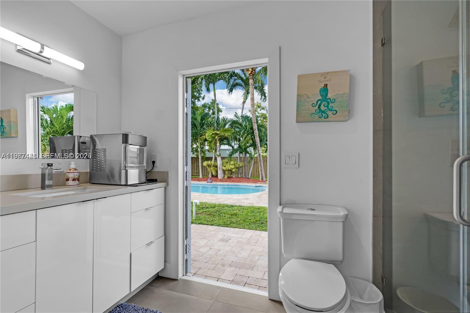 10471 Southwest 164th Street Miami, FL 33157 - Photo 12 of 15 a bathroom with a granite countertop toilet sink and mirror