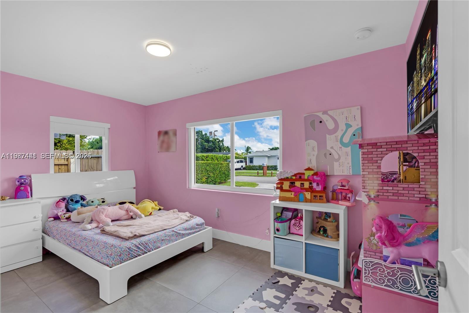 10471 Southwest 164th Street Miami, FL 33157 - Photo 13 of 15 a bedroom with a bed and a dresser in it