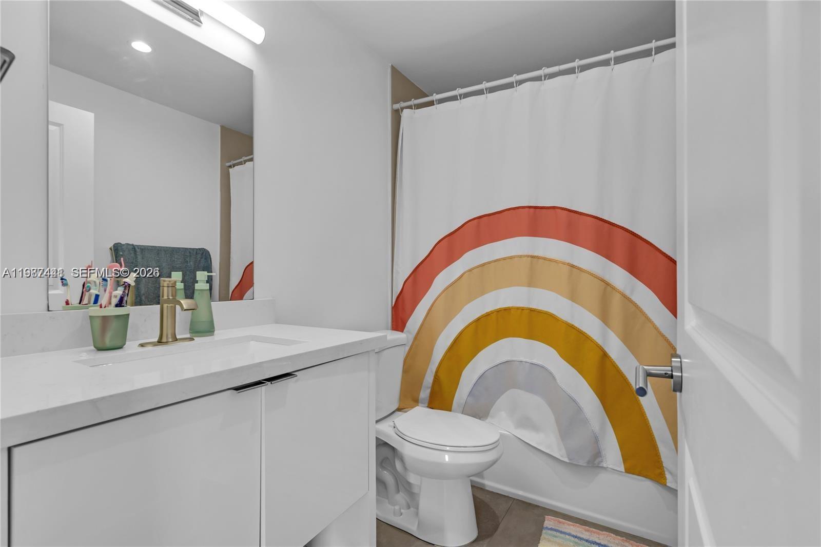 10471 Southwest 164th Street Miami, FL 33157 - Photo 14 of 15 a bathroom with a sink a toilet and a mirror