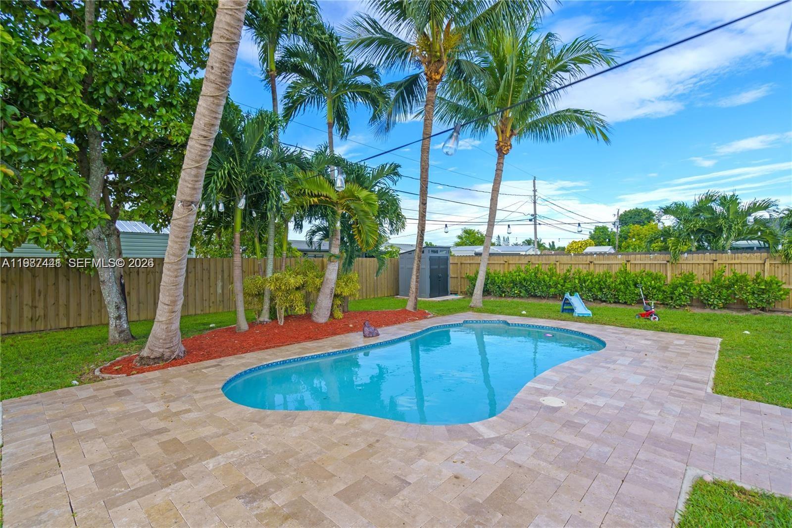 10471 Southwest 164th Street Miami, FL 33157 - Photo 15 of 15 a view of a swimming pool with a patio