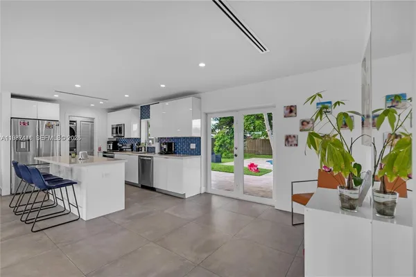 a view of kitchen with furniture and appliances