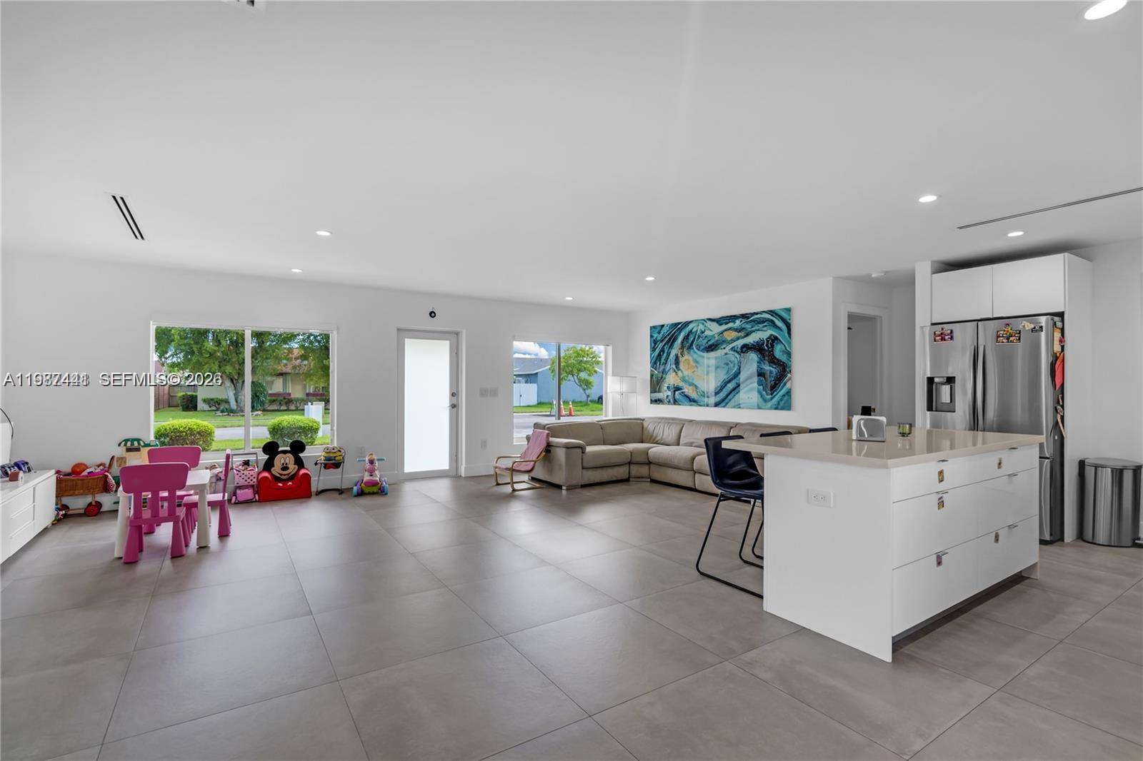 10471 Southwest 164th Street Miami, FL 33157 - Photo 6 of 15 a large living room with furniture and a large window