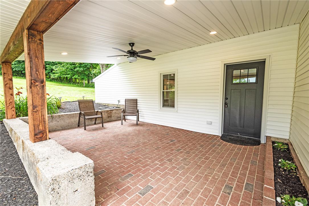 72 Allegheny Road Mount Bethel, PA 18343 - Photo 2 of 72 A welcoming brick patio, covered and lit, invites relaxation with views of nature.