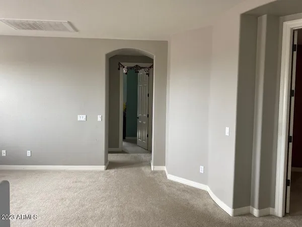 a bedroom with a bed and a chair