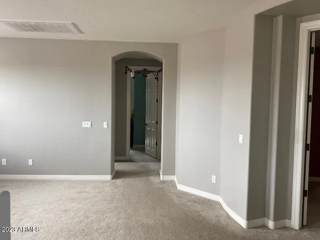 a bedroom with a bed and a chair