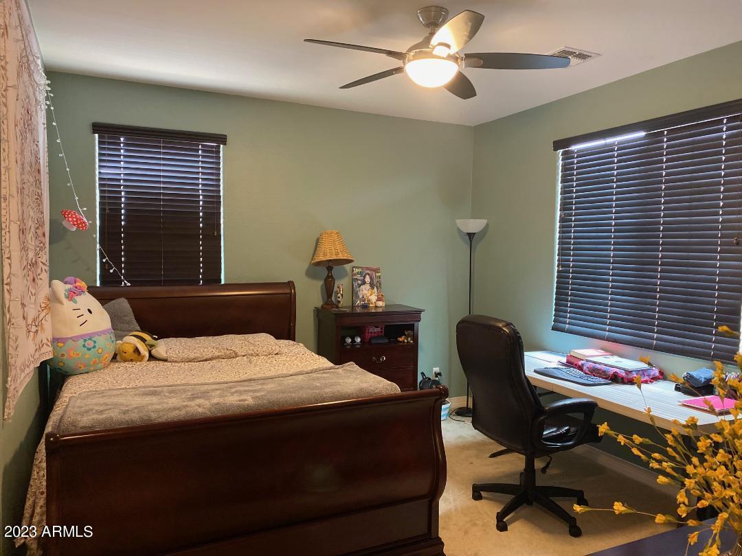 2757 East Powell Way Gilbert, AZ 85298 - Photo 19 of 29 a bedroom with a bed and a chair