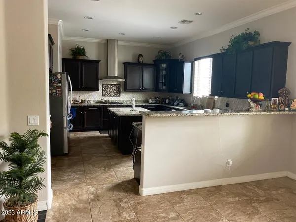 a kitchen with kitchen island granite countertop a sink appliances and cabinets