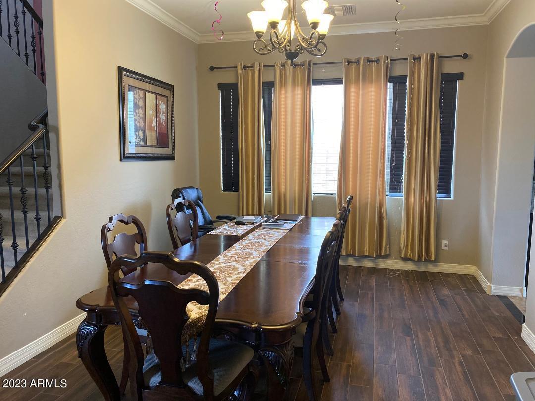 2757 East Powell Way Gilbert, AZ 85298 - Photo 7 of 29 a view of a dining room with furniture window and wooden floor