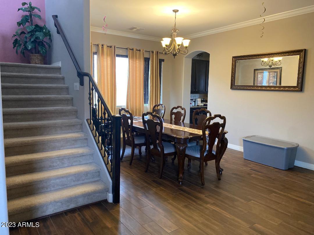 2757 East Powell Way Gilbert, AZ 85298 - Photo 8 of 29 a view of a dining room with furniture and wooden floor