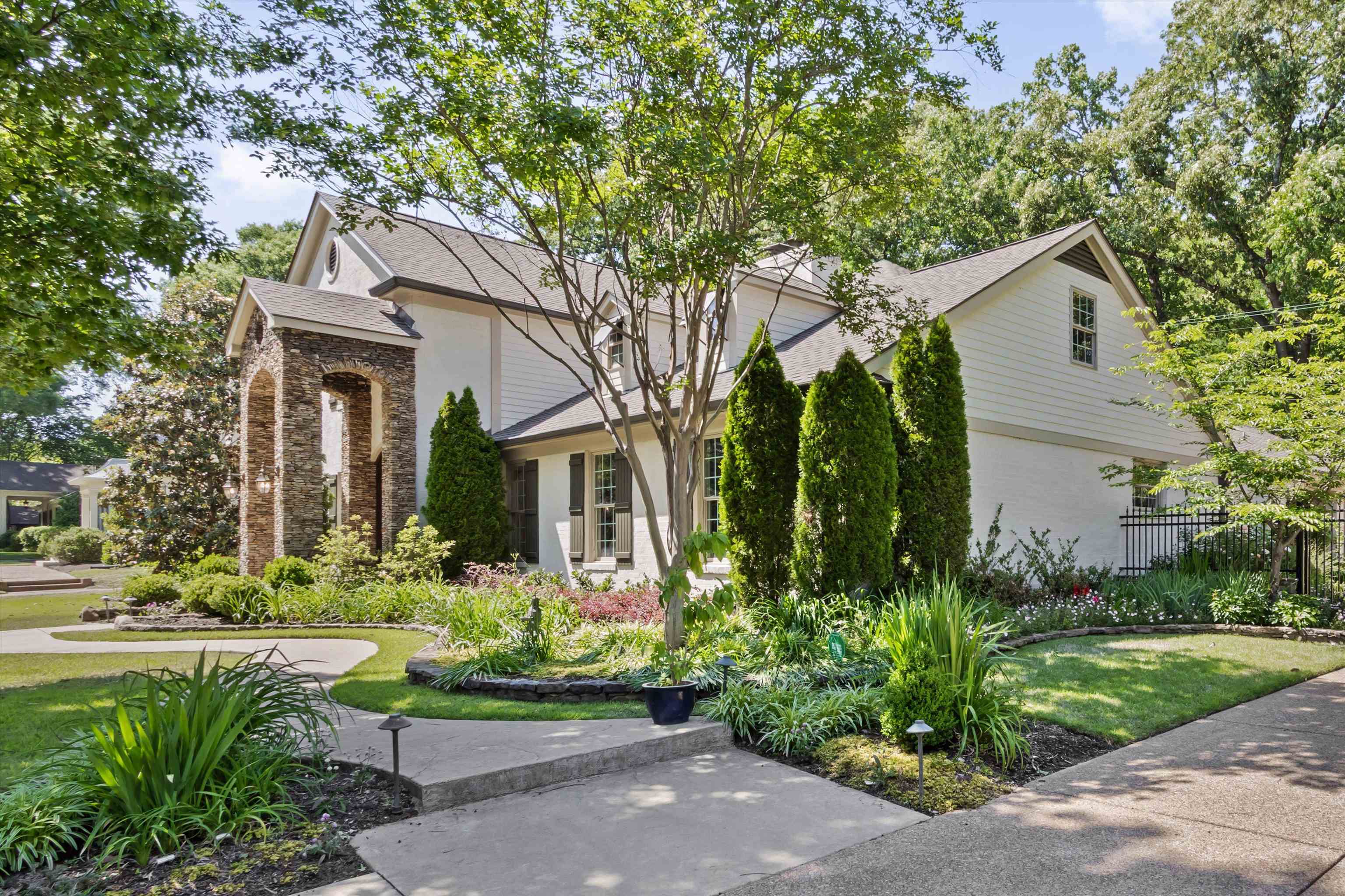 5302 South Angela Road Memphis, TN 38120 - Photo 36 of 40 White siding residence featuring a stone archway entry