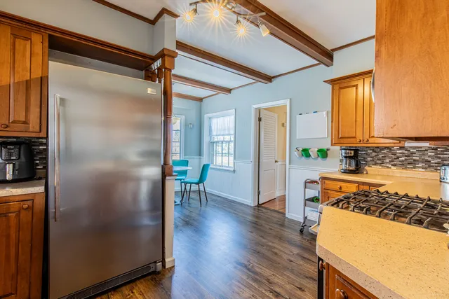 a kitchen with stainless steel appliances granite countertop a refrigerator and a stove