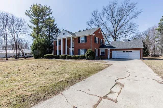 a front view of a building with a yard