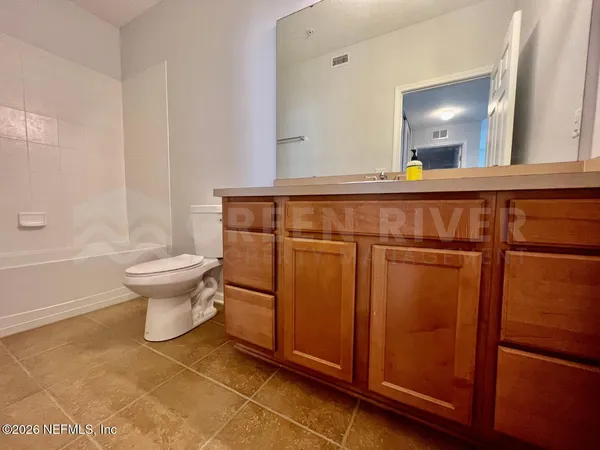 a bathroom with a sink a toilet and mirror