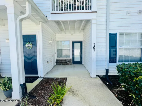 a house with potted plants in front of door