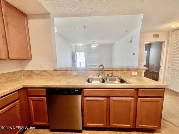 a kitchen with stainless steel appliances granite countertop a sink and cabinets