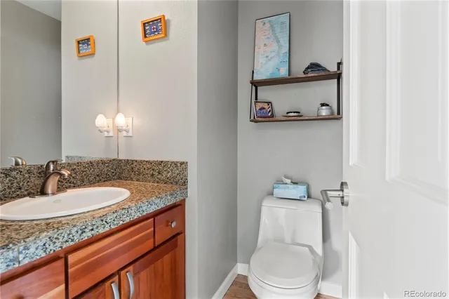 a bathroom with a granite countertop sink and a mirror