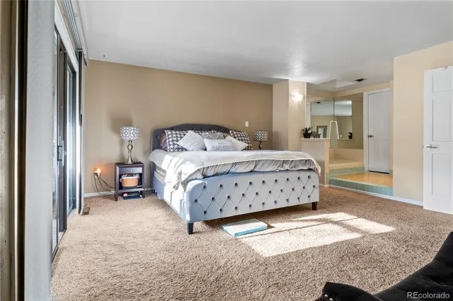 a bedroom with a bed and a mirror