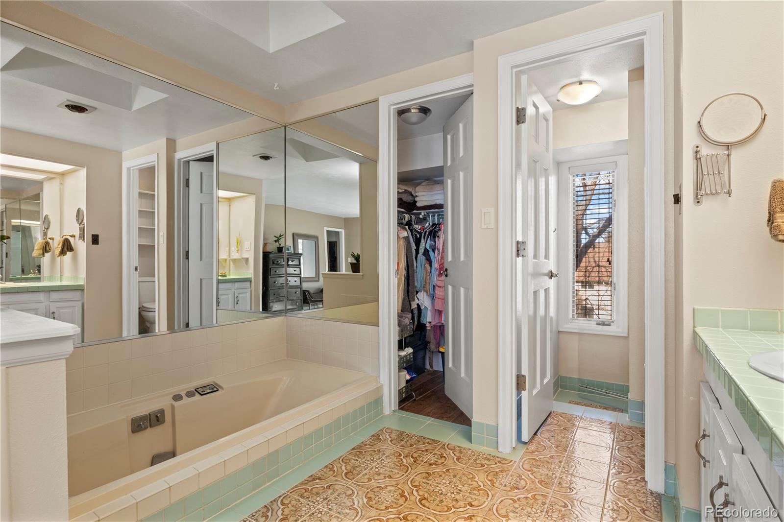 15780 Sandtrap Way Morrison, CO 80465 - Photo 18 of 36 a bathroom with a bathtub and a shower