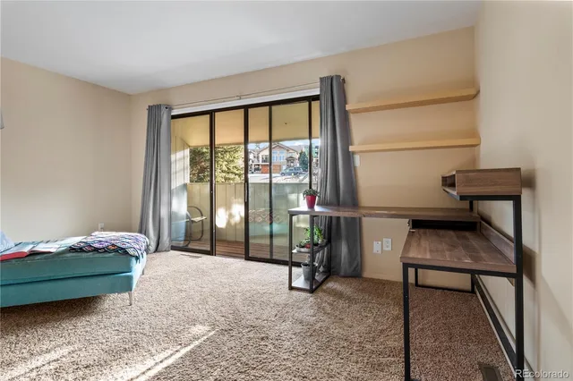 a bedroom with a bed and large window