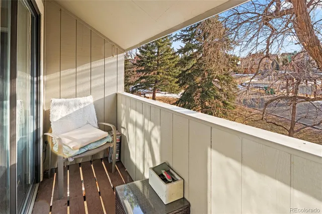 a view of balcony with wooden floor and seating space