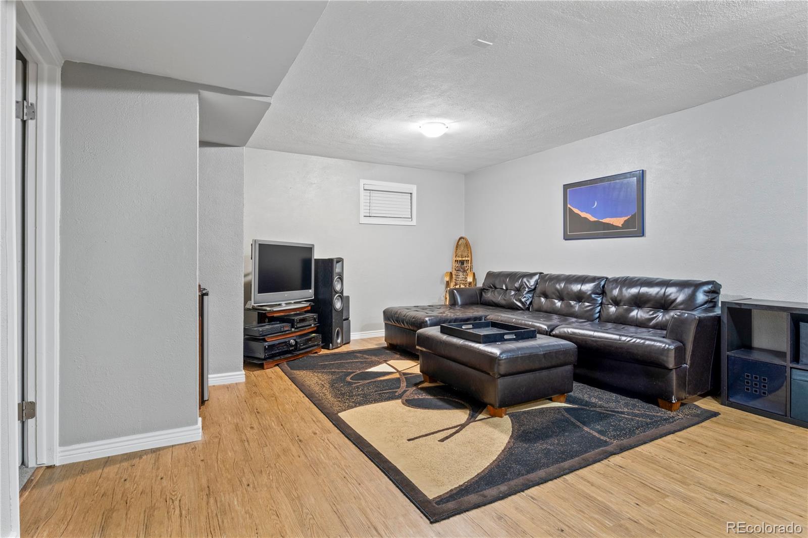 15780 Sandtrap Way Morrison, CO 80465 - Photo 25 of 36 a living room with furniture and a flat screen tv