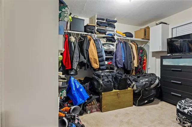 a view of walk in closet with clothes