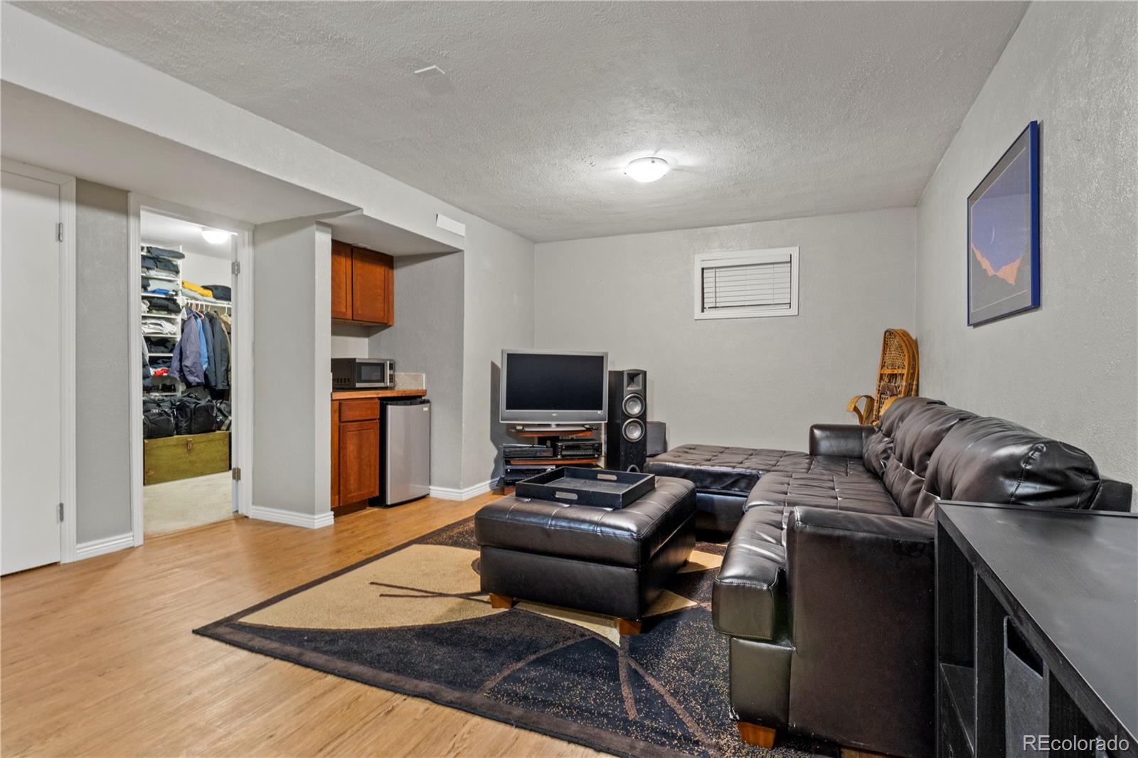 15780 Sandtrap Way Morrison, CO 80465 - Photo 28 of 36 a living room with furniture and a flat screen tv