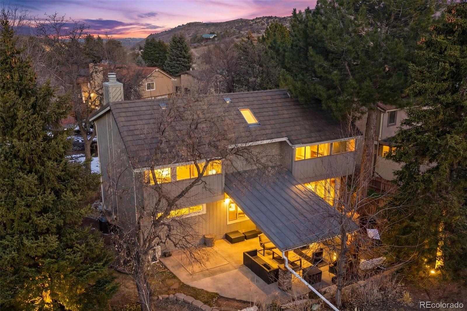 15780 Sandtrap Way Morrison, CO 80465 - Photo 3 of 36 an aerial view of a house with swimming pool and mountains