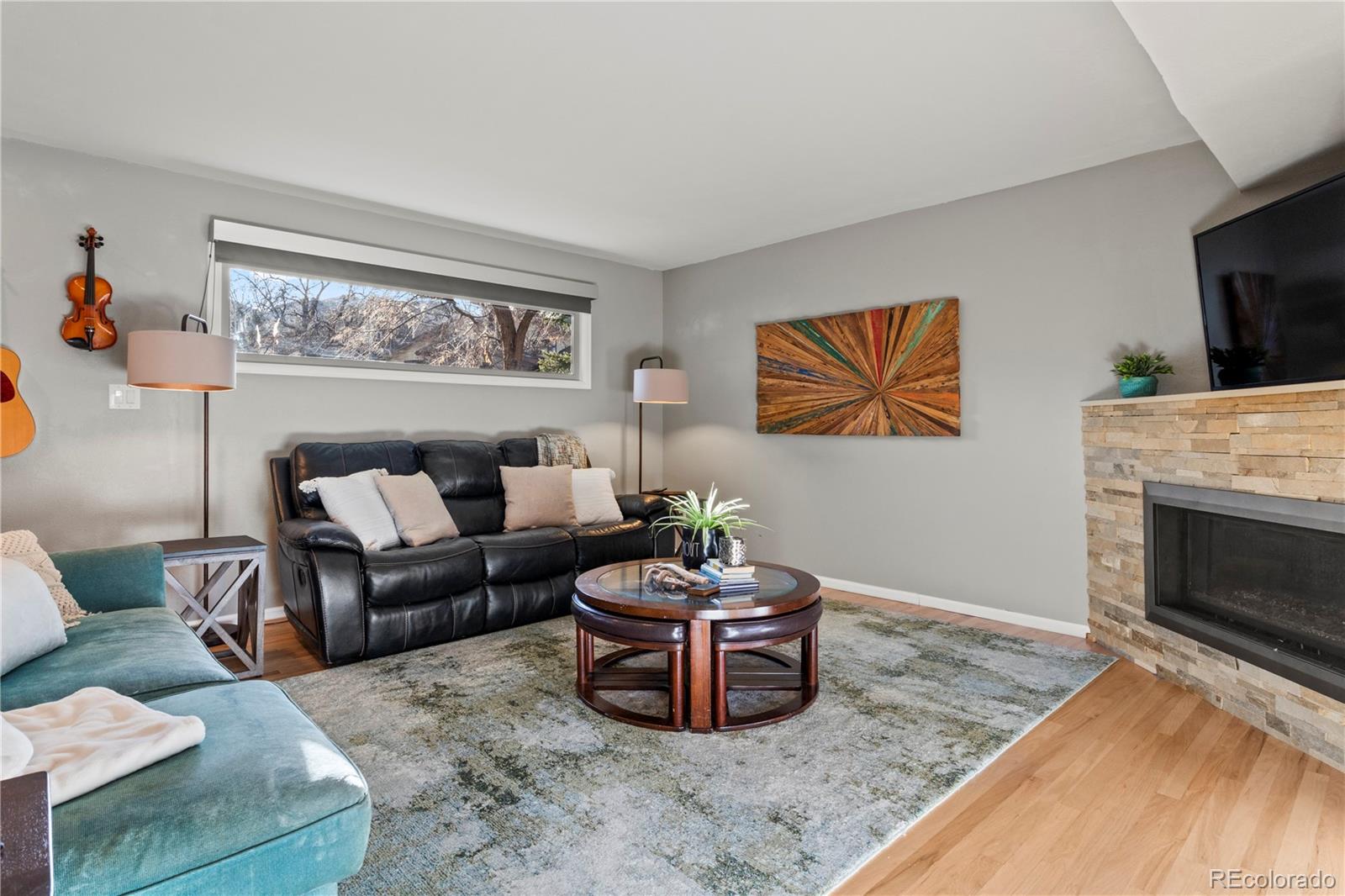 15780 Sandtrap Way Morrison, CO 80465 - Photo 5 of 36 a living room with furniture a flat screen tv and a fireplace