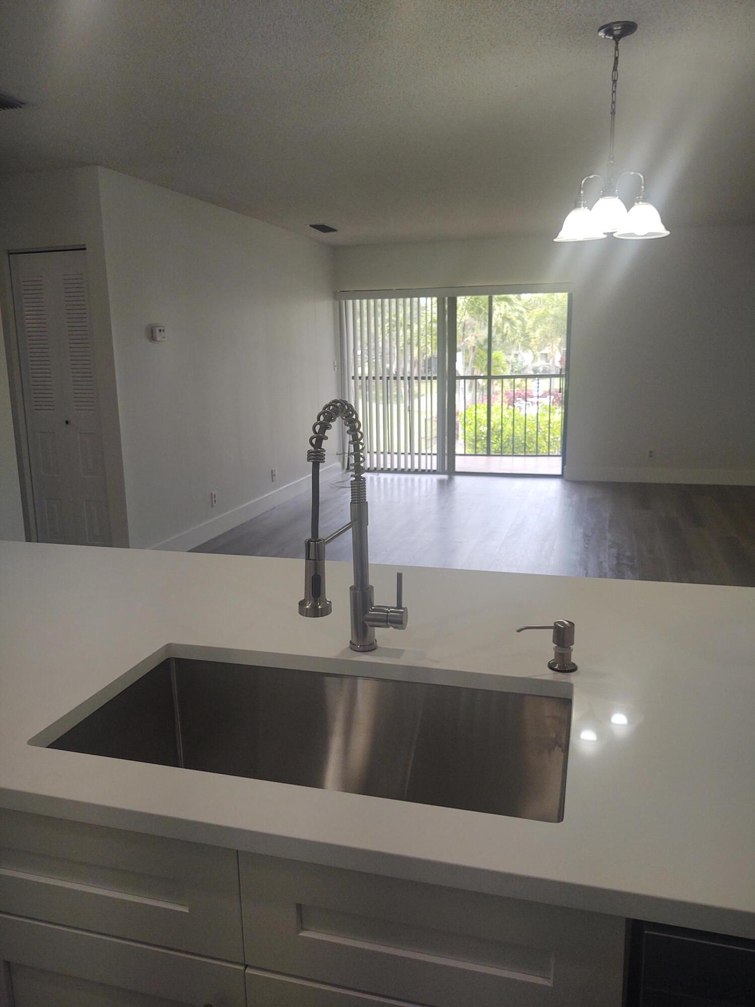 140 Northwest 70th Street, Unit 2040 Boca Raton, FL 33487 - Photo 4 of 18 a close view of sink and tap