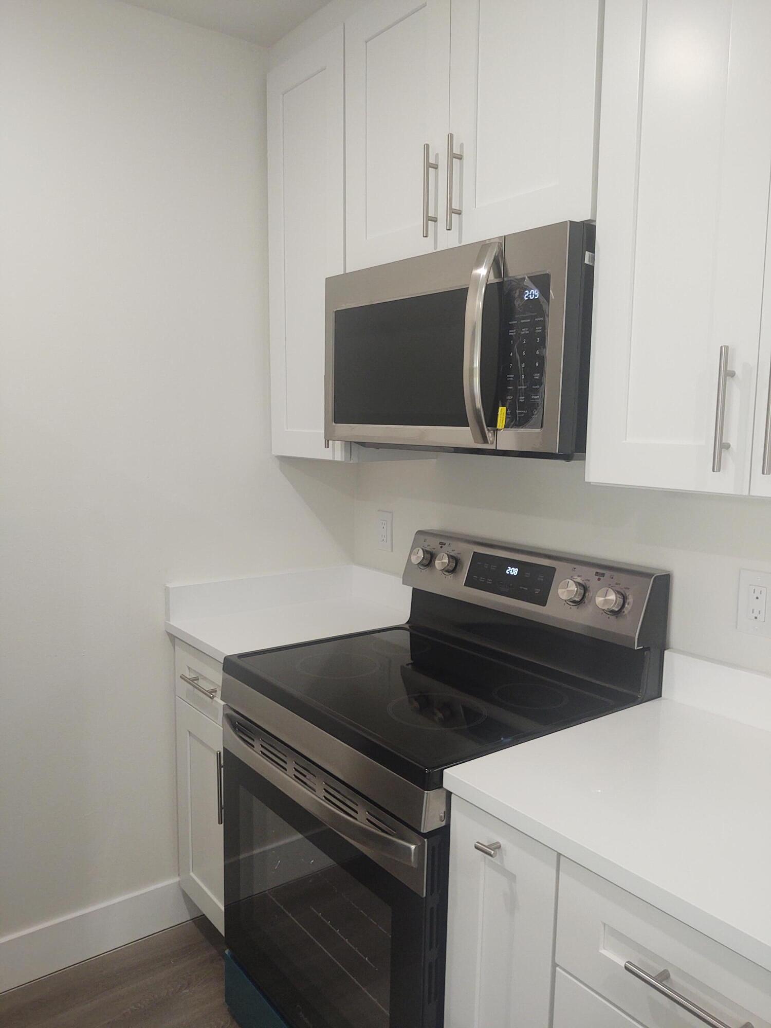 140 Northwest 70th Street, Unit 2040 Boca Raton, FL 33487 - Photo 5 of 18 a stove top oven sitting inside of a kitchen