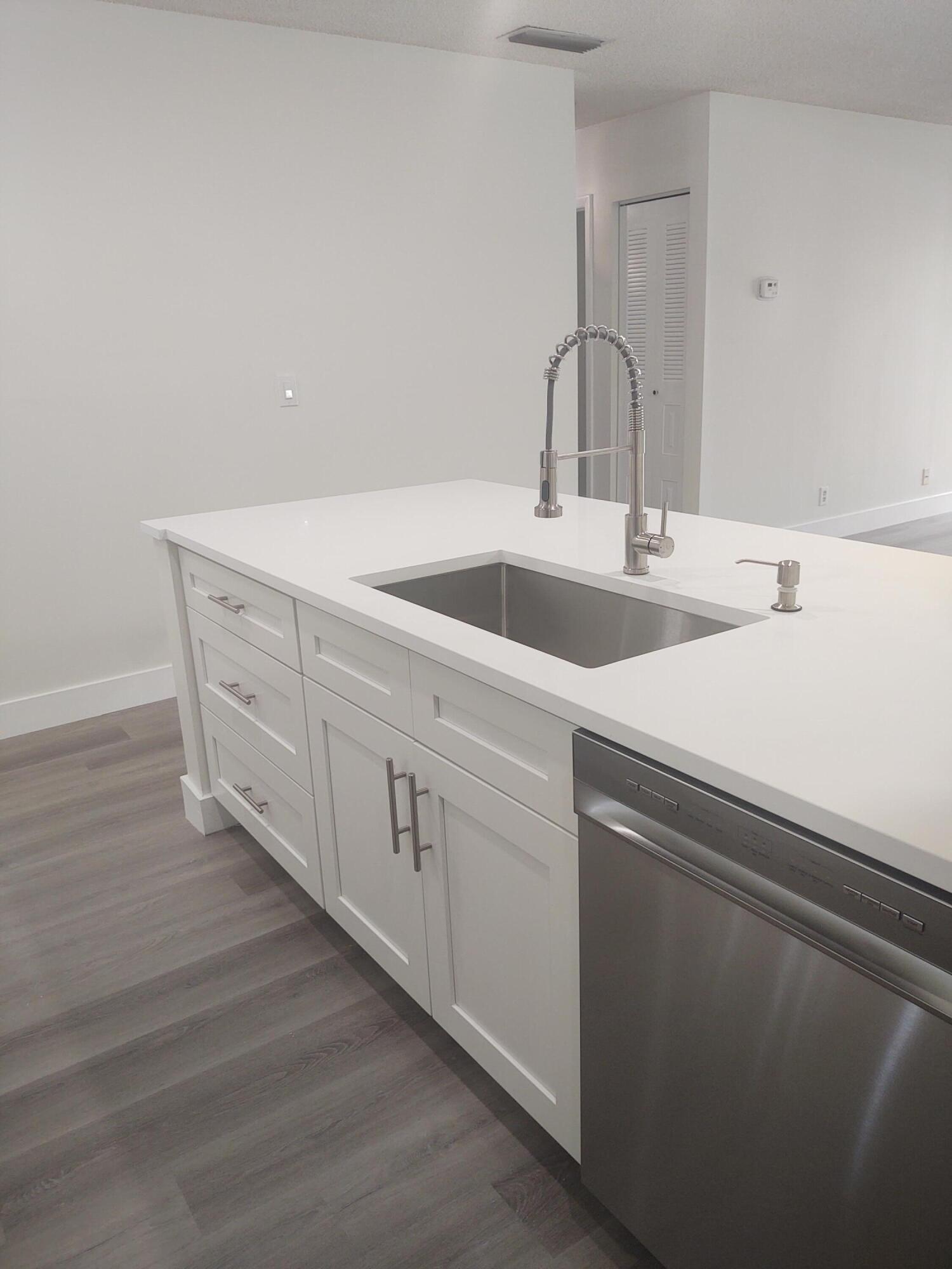 140 Northwest 70th Street, Unit 2040 Boca Raton, FL 33487 - Photo 7 of 18 a close view of sink and tap