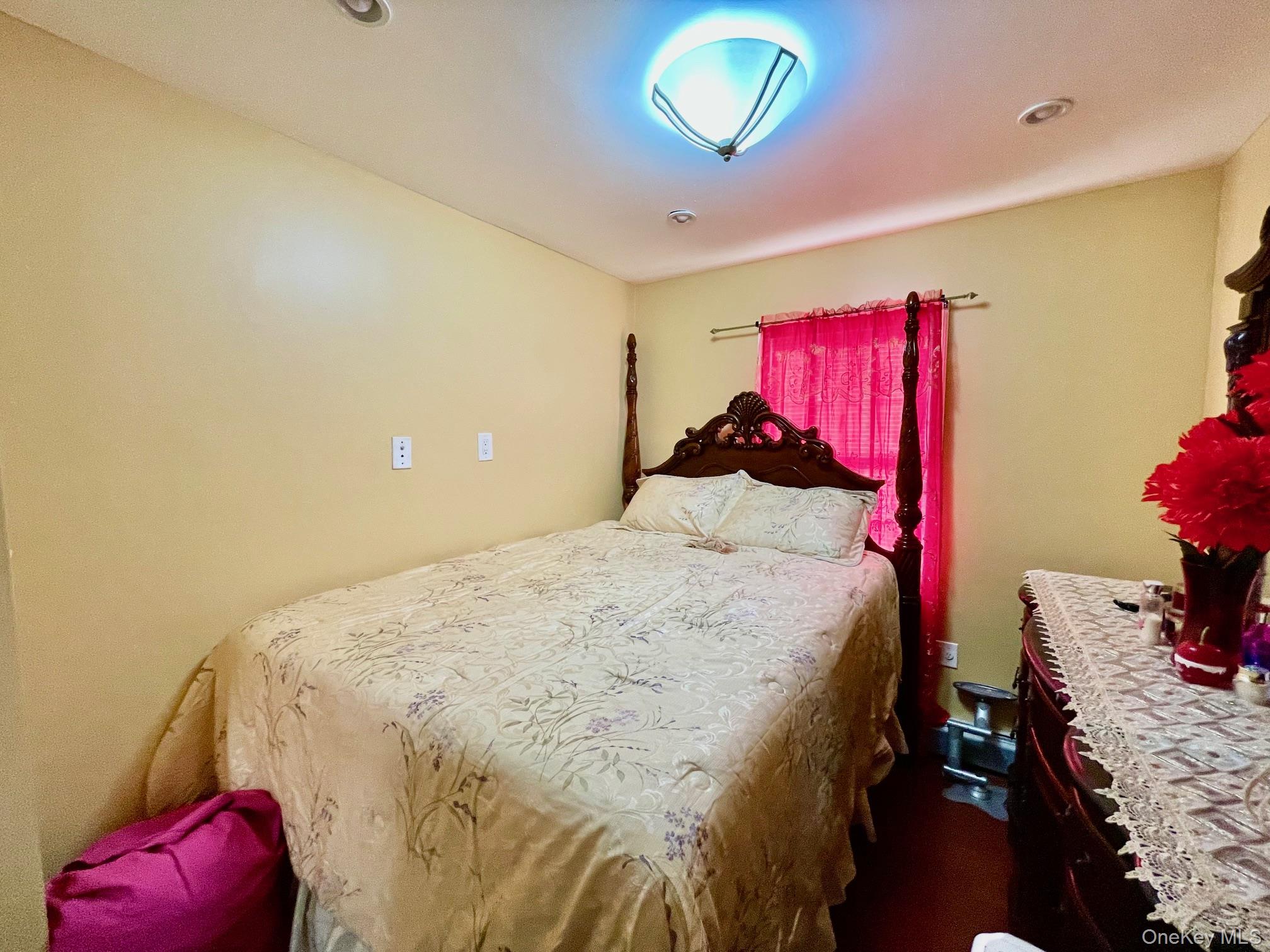 102-03 Rau Court Queens, NY 11414 - Photo 4 of 12 a bedroom with a bed and a window