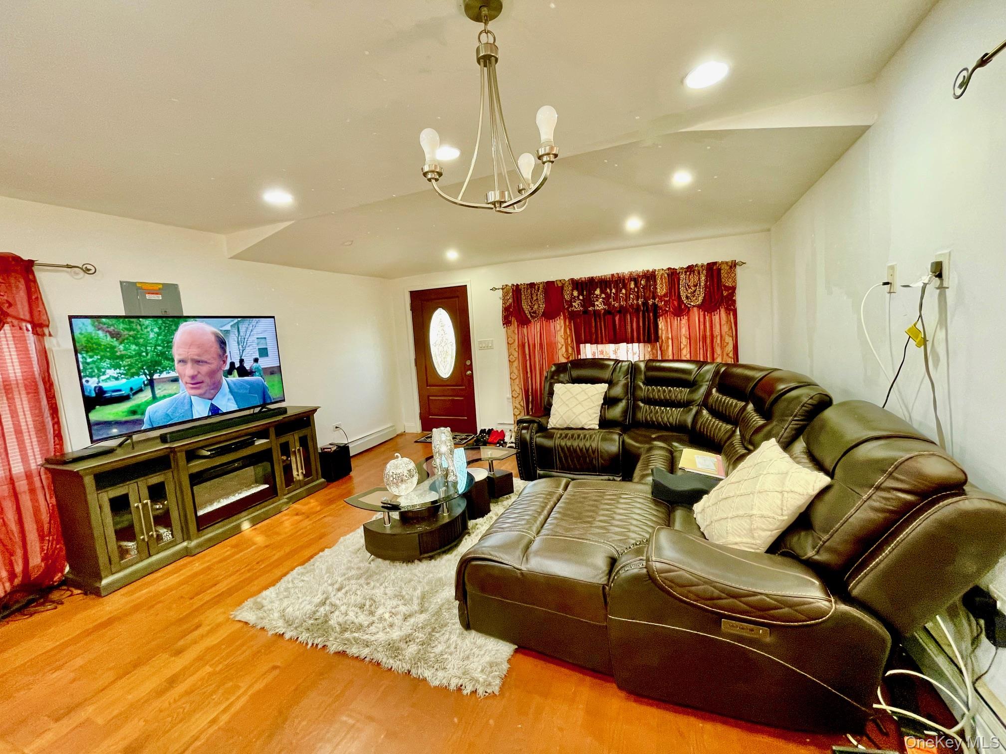 102-03 Rau Court Queens, NY 11414 - Photo 9 of 12 a living room with furniture and a flat screen tv