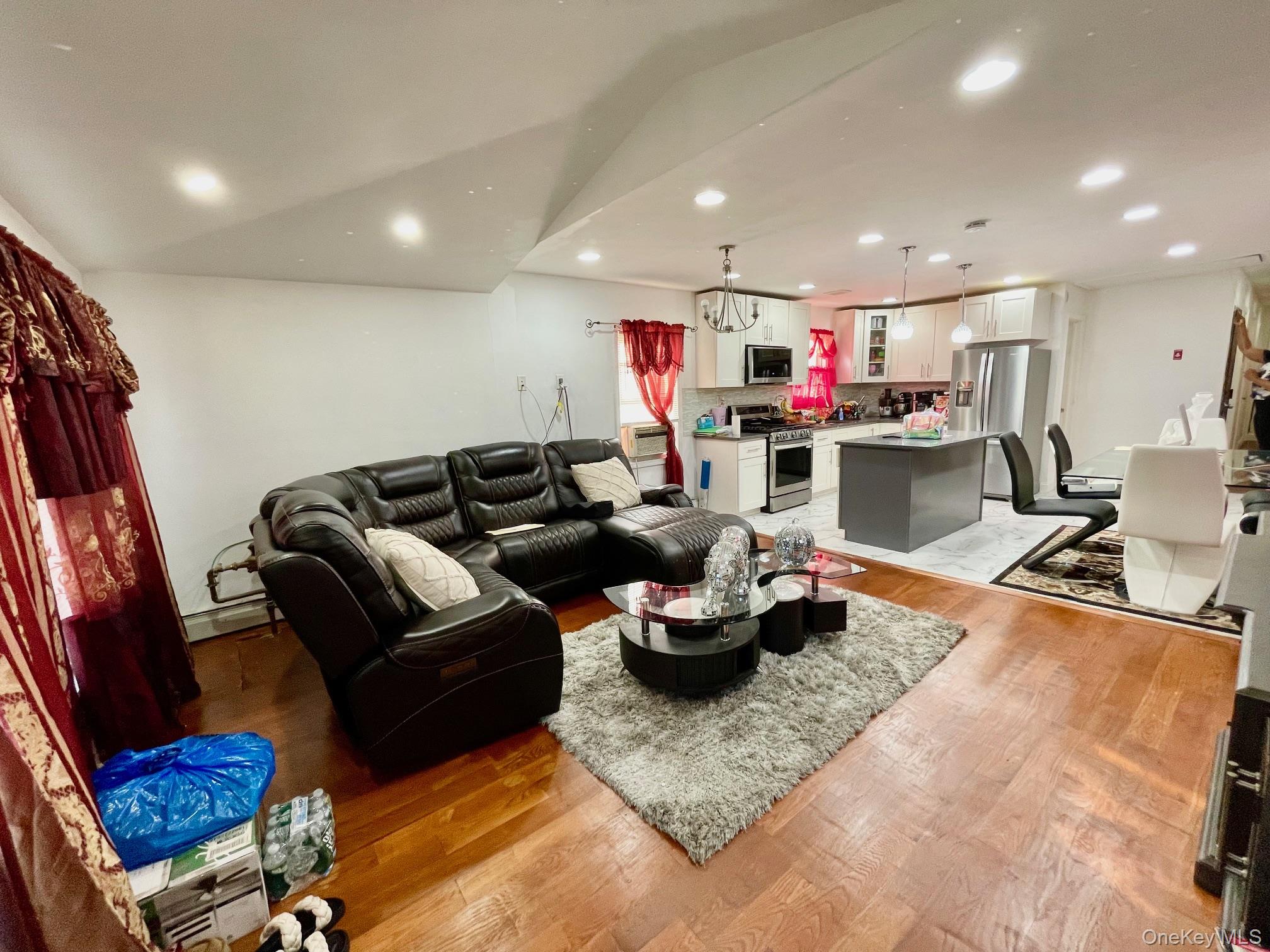 102-03 Rau Court Queens, NY 11414 - Photo 10 of 12 a living room with furniture and a flat screen tv