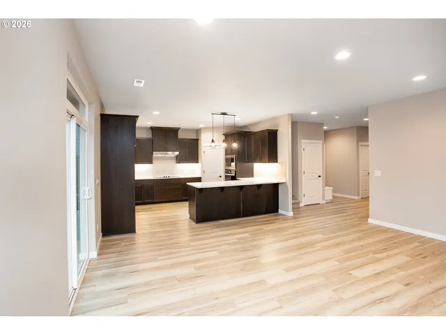 a kitchen with kitchen island a sink counter top space and stainless steel appliances
