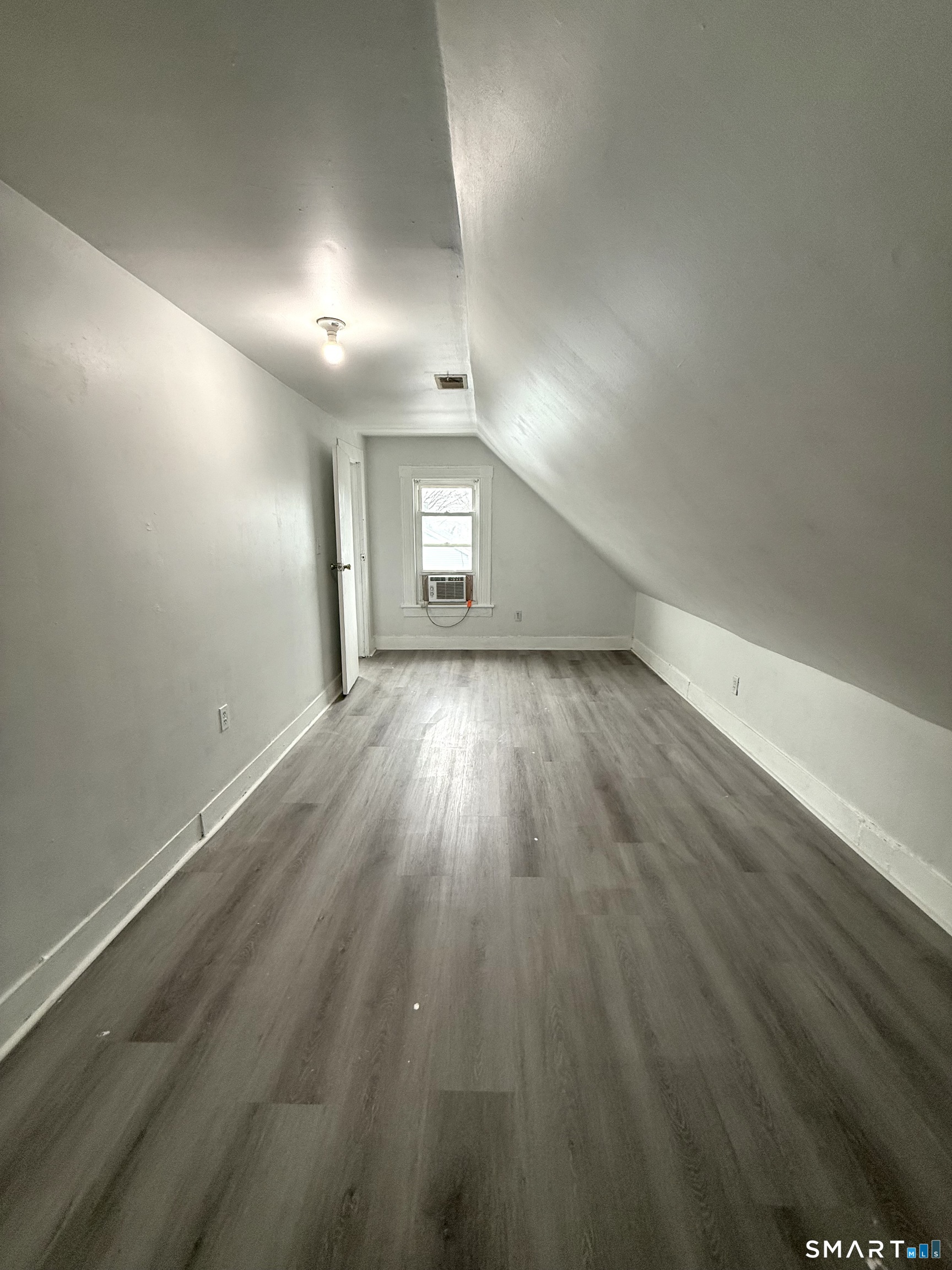 21 Edgar Street, Unit 2 New Haven, CT 06519 - Photo 13 of 20 an empty room with wooden floor and windows