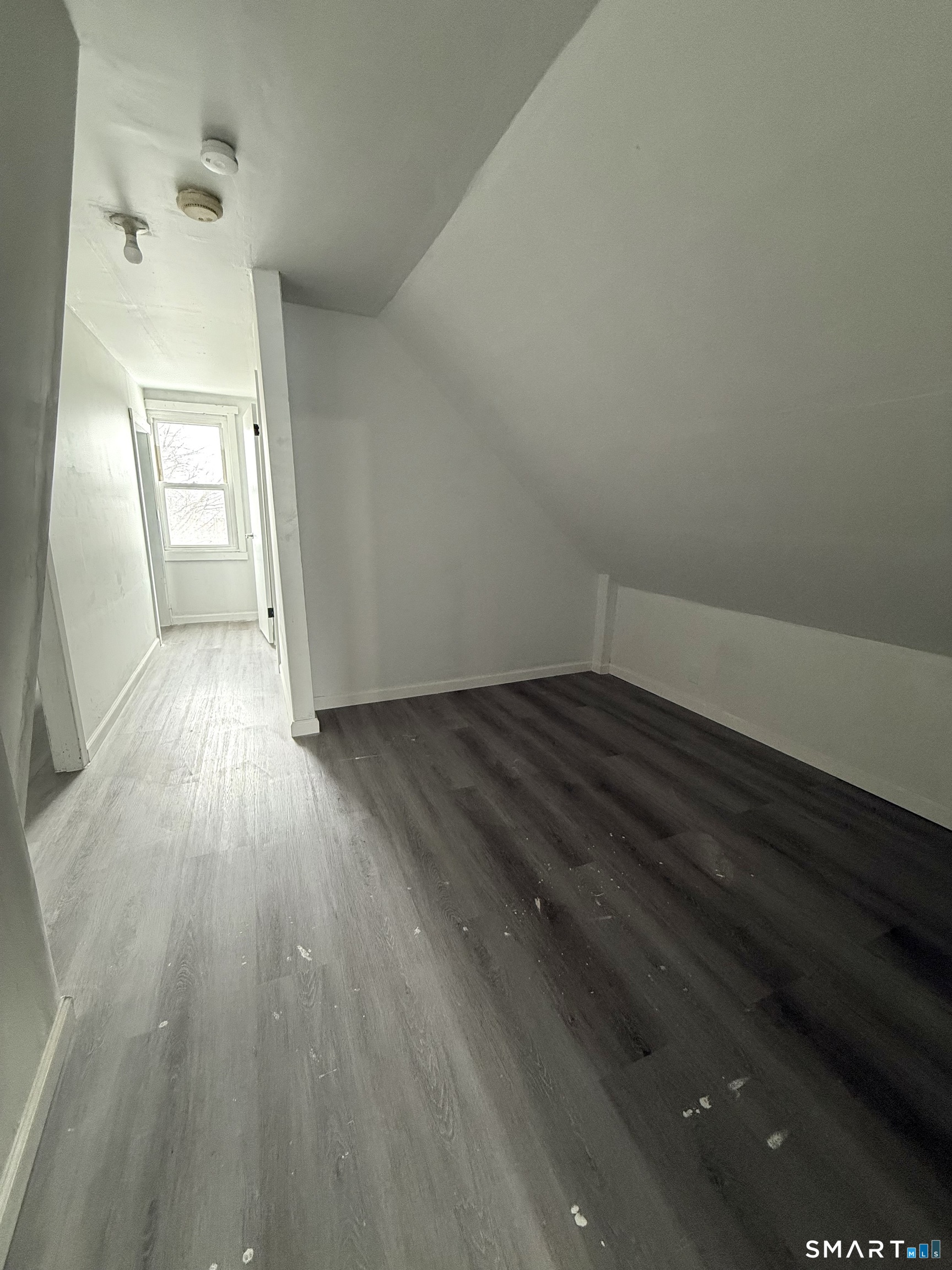 21 Edgar Street, Unit 2 New Haven, CT 06519 - Photo 15 of 20 an empty room with wooden floor and windows