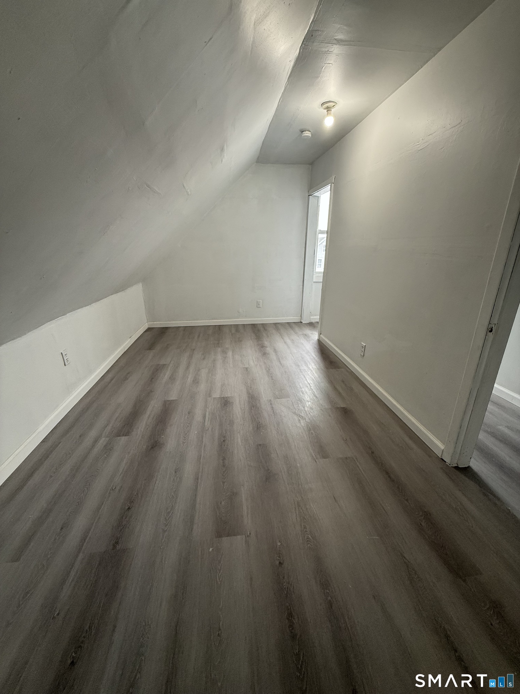 21 Edgar Street, Unit 2 New Haven, CT 06519 - Photo 16 of 20 an empty room with wooden floor and windows
