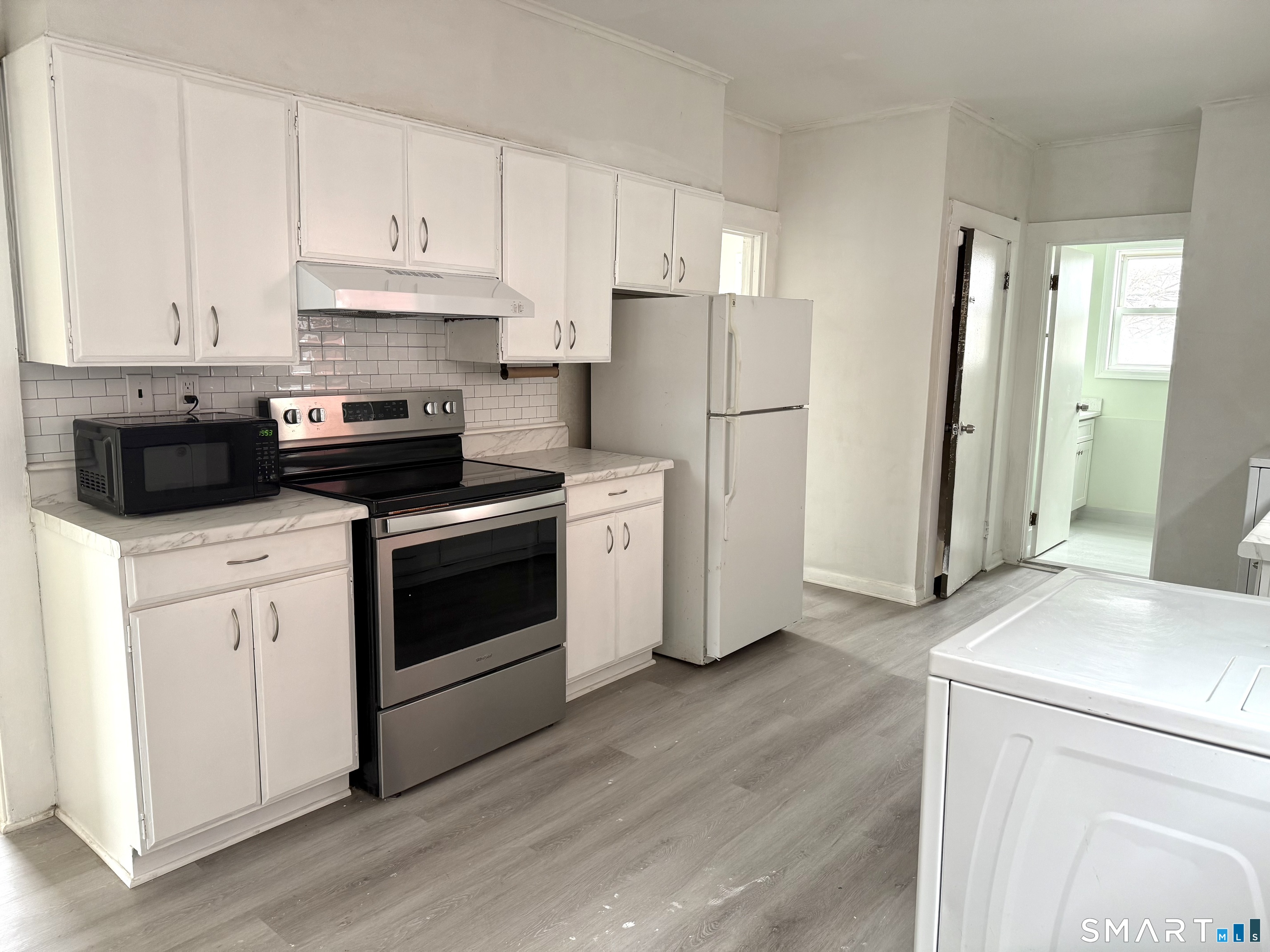 21 Edgar Street, Unit 2 New Haven, CT 06519 - Photo 3 of 20 a kitchen with cabinets stainless steel appliances and wooden floor