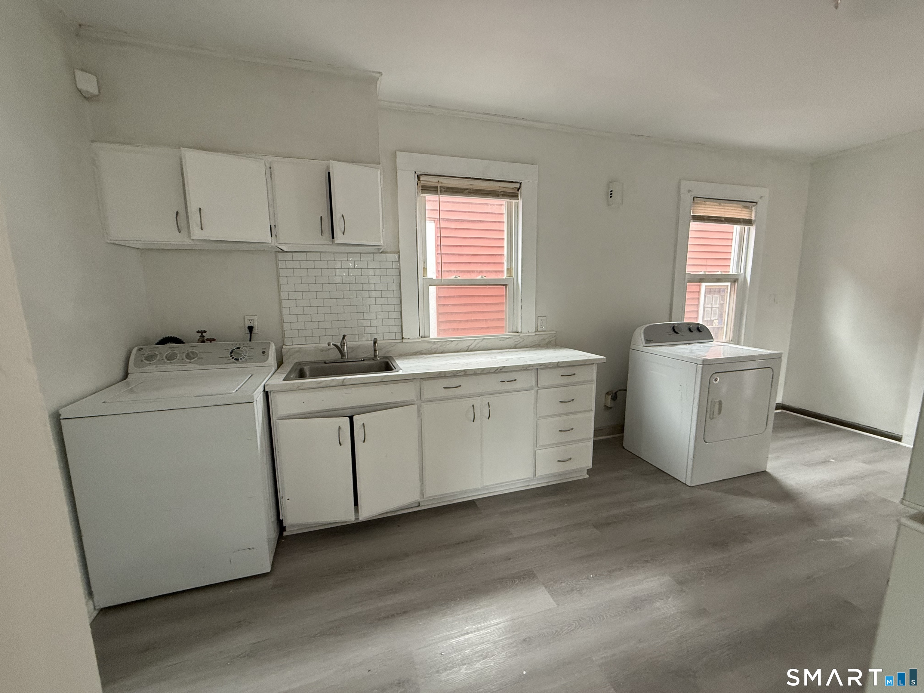 21 Edgar Street, Unit 2 New Haven, CT 06519 - Photo 4 of 20 a utility room with cabinets washer and dryer