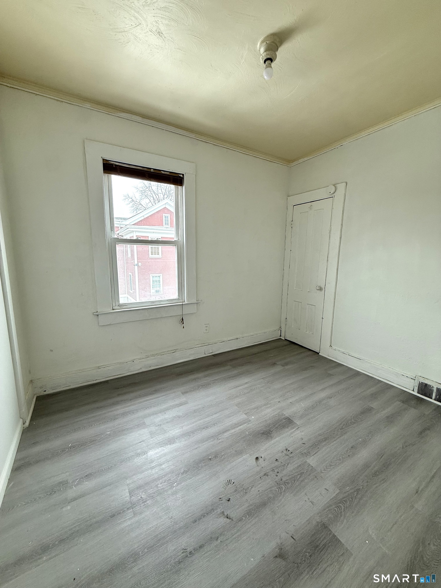 21 Edgar Street, Unit 2 New Haven, CT 06519 - Photo 8 of 20 an empty room with wooden floor and windows